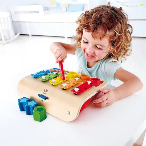 Toddler playing with a xylophone