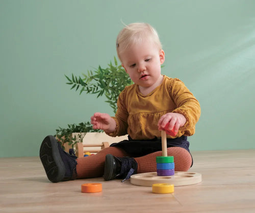 Toddler using a stacking toy