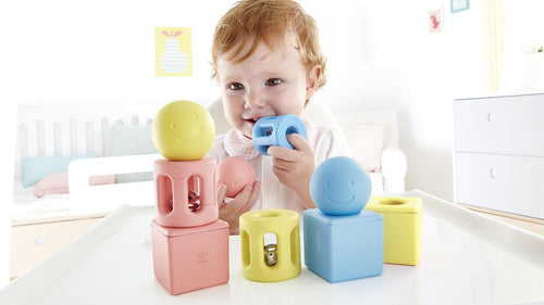 infant playing with developmental toys